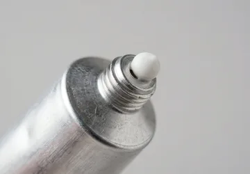 Illustrative unbranded aluminium tube nozzle detail.