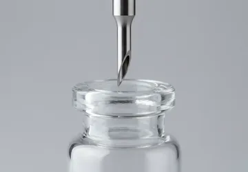 Illustrative unbranded vial neck and filling nozzle detail.